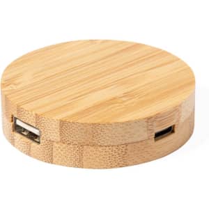 A round bamboo charging station with USB ports, showcasing a natural wood finish and a smooth surface.
