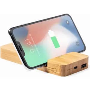 A phone stand made of bamboo, featuring a charging station and a visible phone displaying a battery icon.