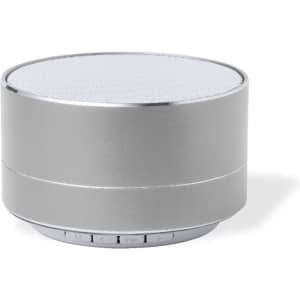 A silver Bluetooth speaker with a round shape and a mesh top, featuring a simple control panel on the side.