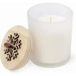 A scented candle in a frosted glass container, topped with a wooden lid featuring a snowflake design.