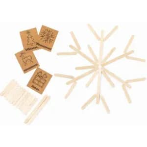 A set of wooden craft sticks arranged in a snowflake pattern, with decorated square cards nearby.