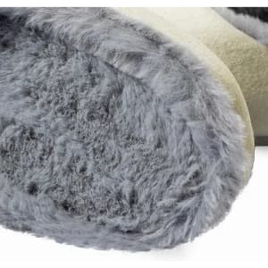 A grey and cream slipper with a fluffy interior and a soft texture. It features a rounded edge for comfort.