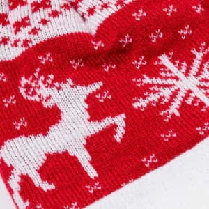 A red and white knitted fabric featuring a reindeer and snowflakes in a festive pattern.