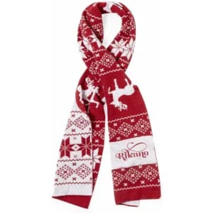 A red scarf with white patterns, including reindeer and snowflakes, featuring a logo.