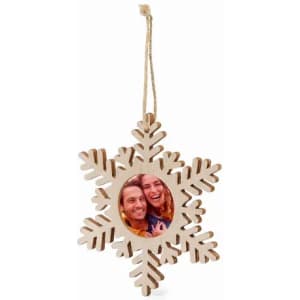 A wooden snowflake ornament featuring a circular photo frame in the centre, with a string for hanging.