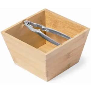 A bamboo container with metallic pliers inside. The container is square-shaped and has a natural wood finish.