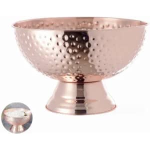 A copper bowl with a hammered finish on a pedestal base, showcasing a shiny, reflective surface.