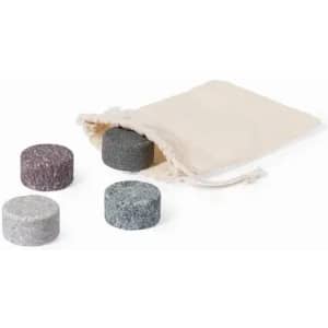 A set of four round, textured stones in grey, black, and light purple, beside a drawstring pouch.