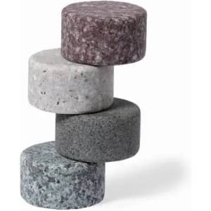 A stack of four round stones in shades of grey, black, and brown, with a smooth texture and varying patterns.