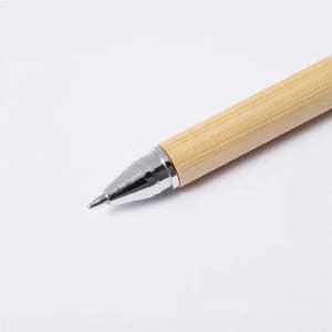 A pen with a bamboo barrel and a chrome tip, showcasing a sleek and natural design.