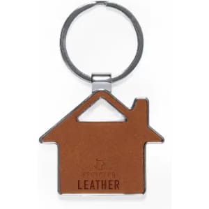 A keyring shaped like a house with a brown leather surface and a silver metal ring.