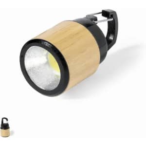 A flashlight with a bamboo body and a black plastic top, featuring a clip for easy attachment.