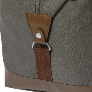 A bag featuring a grey fabric body with brown leather accents and a metal fastening. It has a clean, stylish design.