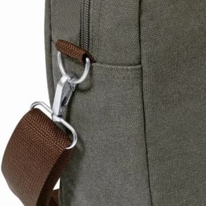 A green bag with a brown strap, featuring a metal clip and a textured fabric surface.