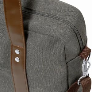 A grey fabric bag with a brown adjustable strap and silver fittings, featuring a zipper closure and stitching details.