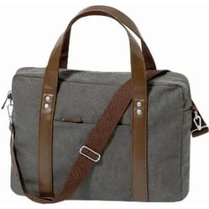 A grey bag with brown leather handles and a detachable strap, featuring front pockets and a minimalist design.