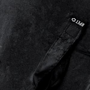 A black fabric bag with a textured surface and a handle, featuring a logo on the strap.