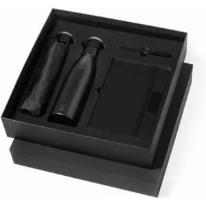A drink bottle, a notebook, and a pen presented in a black gift box with a black umbrella.
