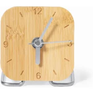 A bamboo alarm clock with a square design, silver hands, and a small metal stand.