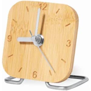 A bamboo clock with a square face, silver hands, and a metal stand, featuring simple hour markers.