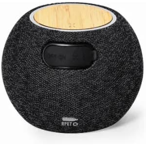 A portable speaker featuring a black fabric exterior and a wooden top, with controls on the front and a logo on the base.