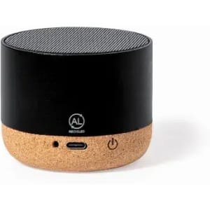 A black and cork Bluetooth speaker featuring a textured top and a branding logo on the front.