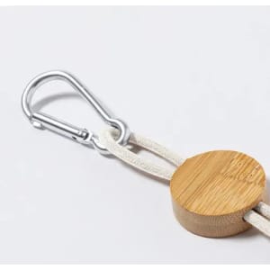 A bamboo clip with a silver carabiner attached to a beige strap.
