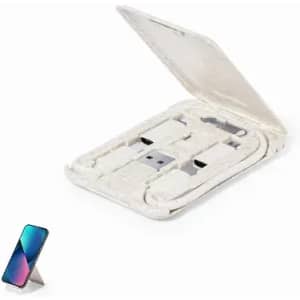 A portable phone charger in a silver case with a USB connector and a phone on a stand beside it.