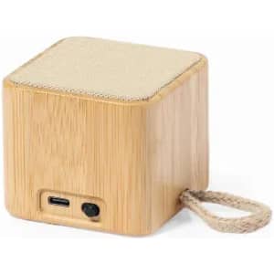 A wooden Bluetooth speaker with a square shape, featuring a fabric top and a rope handle for portability.