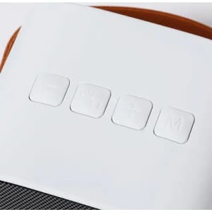 A close-up of a white device with four control buttons on the surface, featuring a textured pattern underneath.