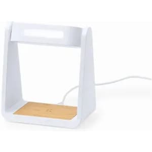 A wireless charging stand with a white frame and a wooden base, featuring a cable connected at the back.