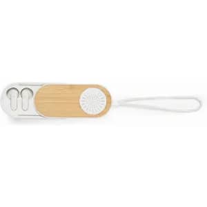 A rectangular storage case with a bamboo panel, housing wireless earphones and a textured white surface.