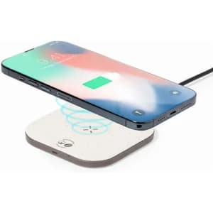 A wireless charging pad with a smartphone hovering above it. The pad features a minimalist design.