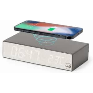 A bedside clock with a wireless charging feature, featuring a sleek design in silver and black. It has a logo on the base.
