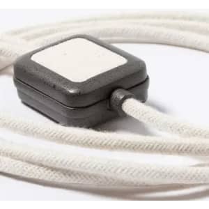 A grey and white rectangular electronic device with a cord, featuring a textured surface.