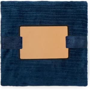 A cushion in a deep navy blue, featuring a smooth rectangular centre and two decorative straps.