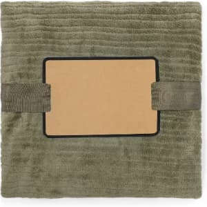 A soft, olive green photo album with an empty frame and two fabric straps for closure.