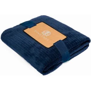 A navy blue, folded blanket with a tan label and fastening straps. The blanket has a soft, textured surface.