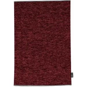 A maroon textured towel with a small brand tag at the bottom. The fabric appears soft and absorbent.