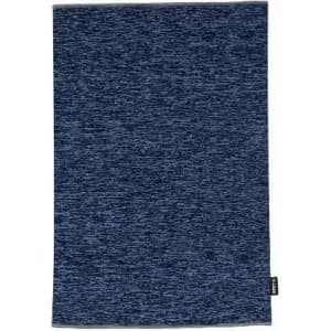 A blue textured towel with a woven pattern and a small tag at the bottom edge.