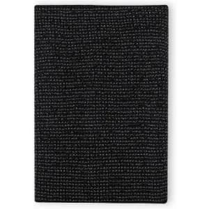 A black textured notebook with a woven pattern and a simple, minimalist design. It features a logo on the cover.