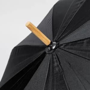 A black umbrella featuring a wooden handle and a structured canopy design. It has a logo on the handle.