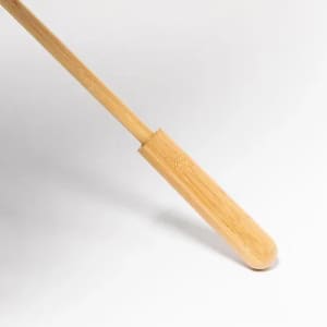 A bamboo handle features a smooth, rounded end with a natural finish, suitable for various uses.