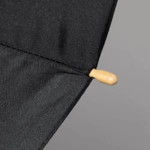 A black umbrella tip with a wooden toggle fastener, designed for secure closure.