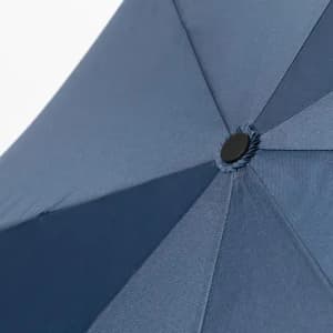 A navy-blue umbrella with a central button and segmented fabric panels. It features a simple, sleek design.