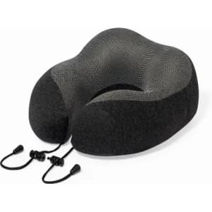 A travel neck pillow in black and grey with adjustable cords for support and comfort. It has a textured surface.