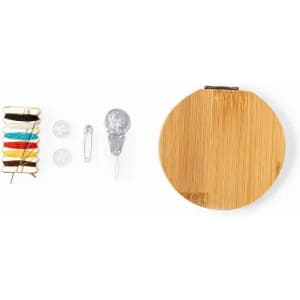 A sewing kit with colourful threads, needles, a safety pin, and a bamboo case.