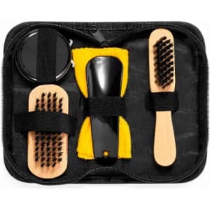 A grooming kit featuring a black zippered case, two wooden brushes, and a comb with a yellow cleaning cloth.