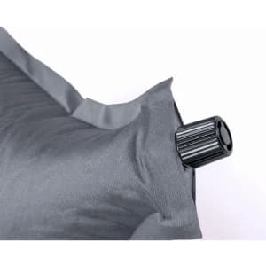 A grey inflatable pillow featuring a black valve for inflation and deflation.