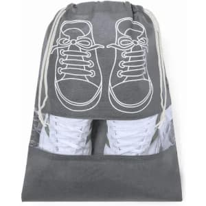 A drawstring bag in grey with a shoe graphic on the front, featuring white sneakers inside.